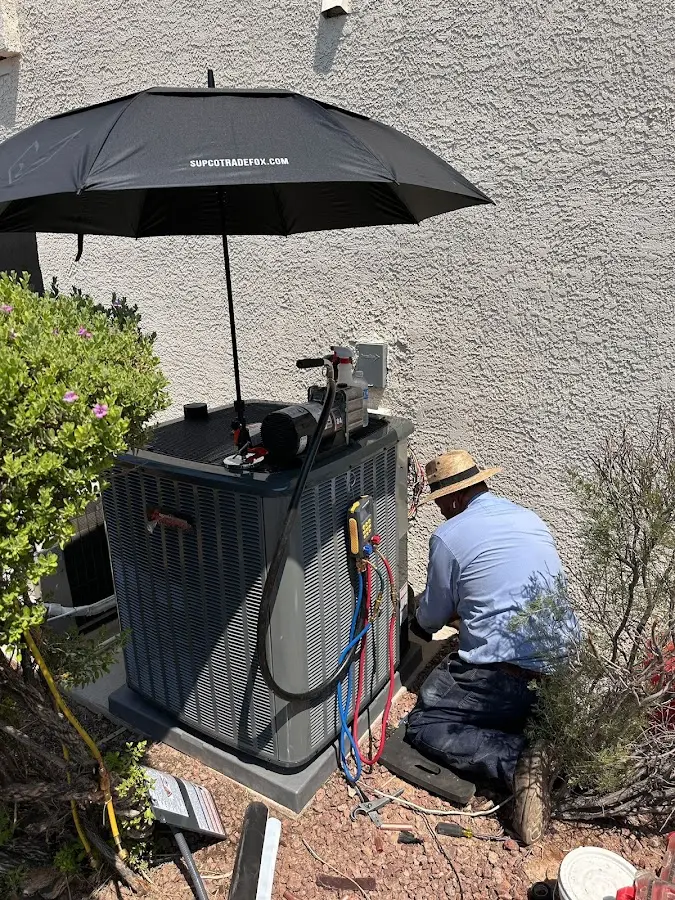 HVAC technician performing outdoor AC maintenance in Lexington